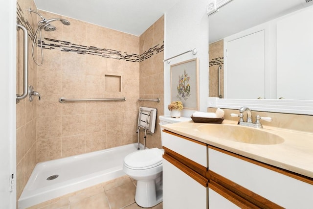 bathroom with toilet, a shower stall, tile patterned flooring, and vanity