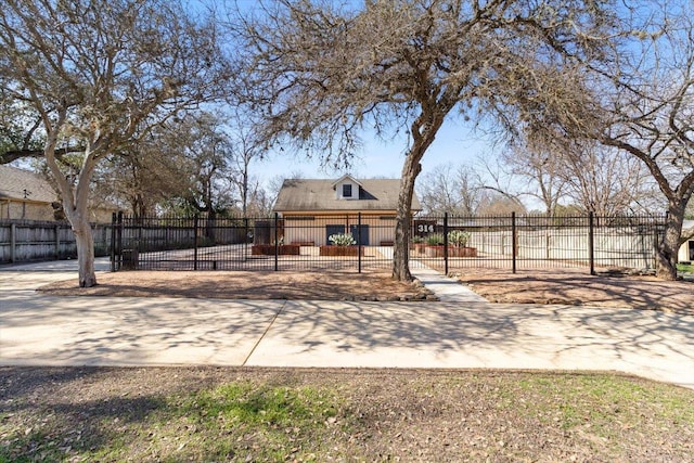 view of yard with a fenced front yard and a gate