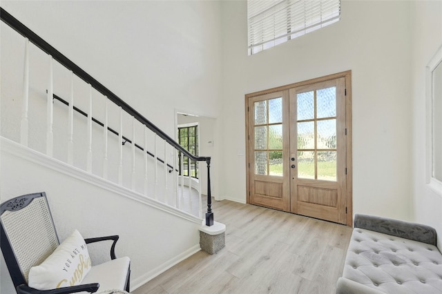 608 Sombrero Dr, Horseshoe Bay, TX 78657 - foyer featuring french doors, plenty of natural light, stairway, and wood finished floors