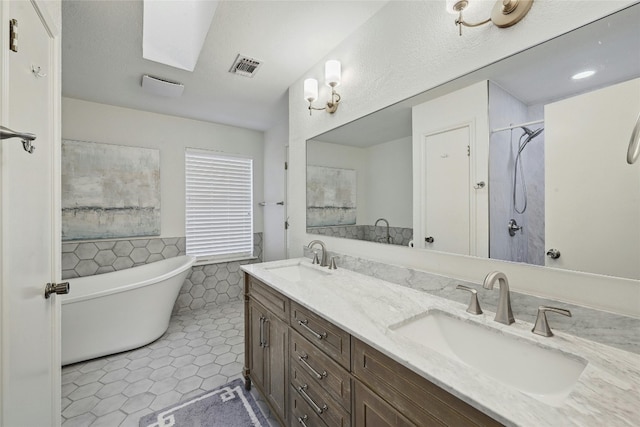 608 Sombrero Dr, Horseshoe Bay, TX 78657 - full bathroom featuring tile walls, tile patterned flooring, visible vents, and a sink