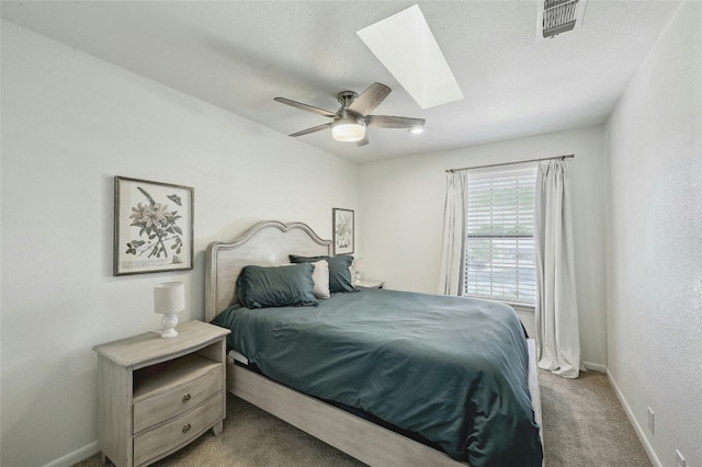 608 Sombrero Dr, Horseshoe Bay, TX 78657 - bedroom featuring ceiling fan, a skylight, visible vents, baseboards, and carpet