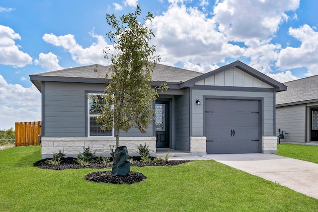 view of front of house featuring concrete driveway, board and batten siding, fence, a garage, and a front lawn