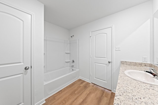 full bath featuring shower / bathing tub combination, vanity, and wood finished floors