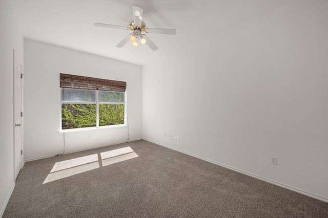 spare room with ceiling fan, carpet flooring, and baseboards