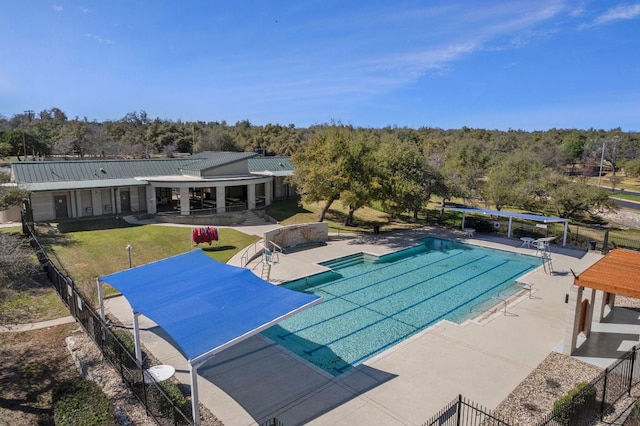 pool featuring a patio area, fence, and a lawn