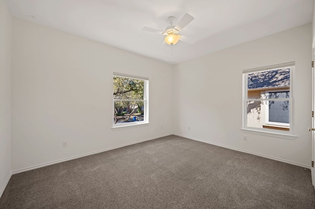 spare room with carpet floors, baseboards, and a ceiling fan