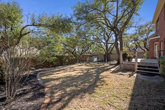 view of yard with a fenced backyard and a wooden deck