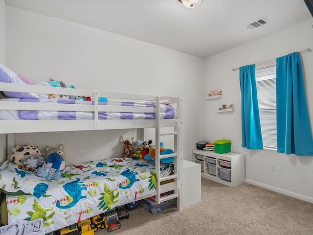 bedroom featuring light carpet, baseboards, and visible vents