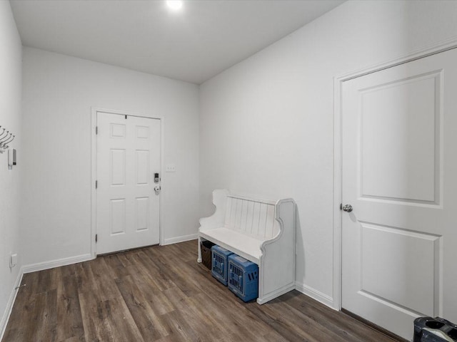 entryway with baseboards and wood finished floors