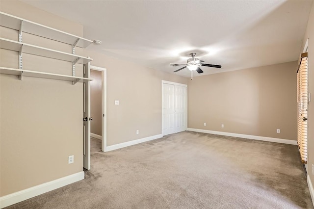 unfurnished bedroom with carpet floors, a ceiling fan, and baseboards