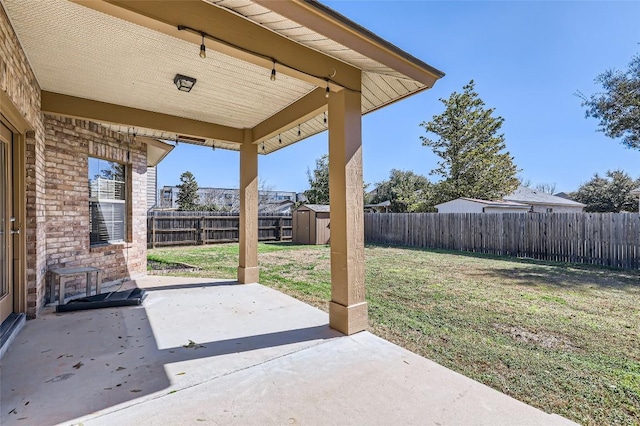 view of patio / terrace featuring a shed, an outdoor structure, and a fenced backyard