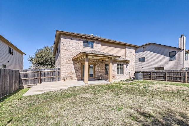 back of house featuring central AC unit, a lawn, a fenced backyard, a patio area, and brick siding