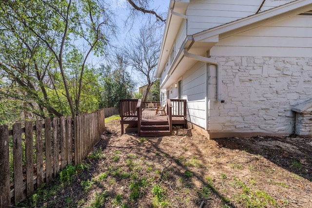 view of yard with fence and a wooden deck