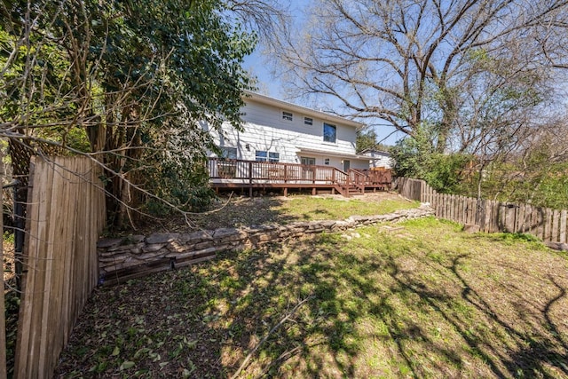 view of yard featuring fence and a deck