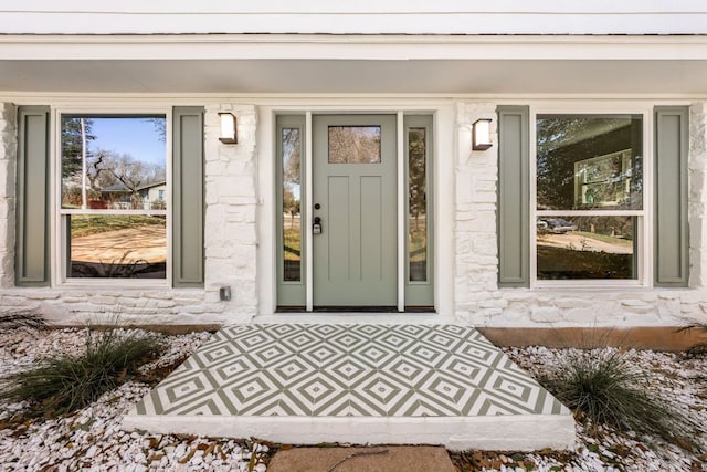 doorway to property with stone siding