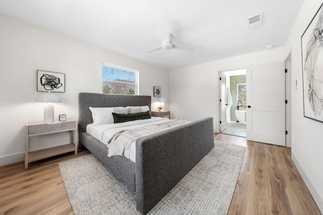 bedroom with baseboards, a ceiling fan, visible vents, and light wood-style floors