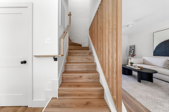 staircase featuring wood finished floors