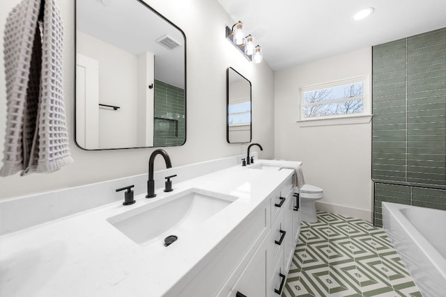 bathroom with toilet, a bathtub, visible vents, and a sink