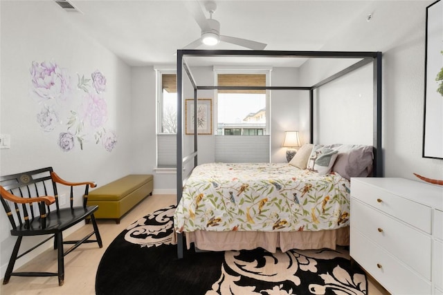 bedroom featuring visible vents, ceiling fan, and light wood-style flooring