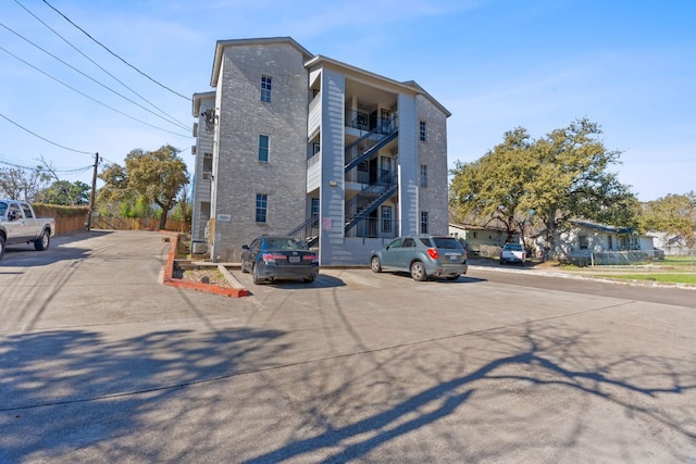 view of building exterior featuring uncovered parking