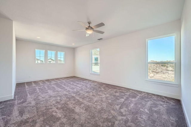 spare room with visible vents, baseboards, ceiling fan, and carpet flooring