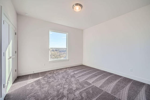 unfurnished bedroom featuring carpet and baseboards