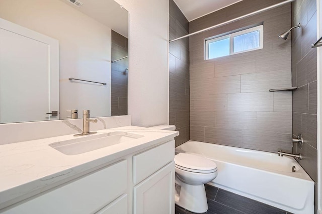 full bathroom with visible vents, vanity, toilet, and shower / bathtub combination