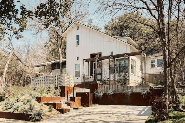 rear view of property featuring stairs