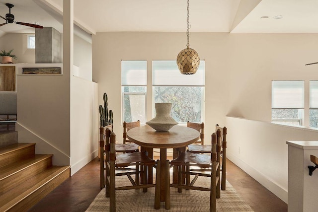 dining room featuring ceiling fan, baseboards, and a wealth of natural light