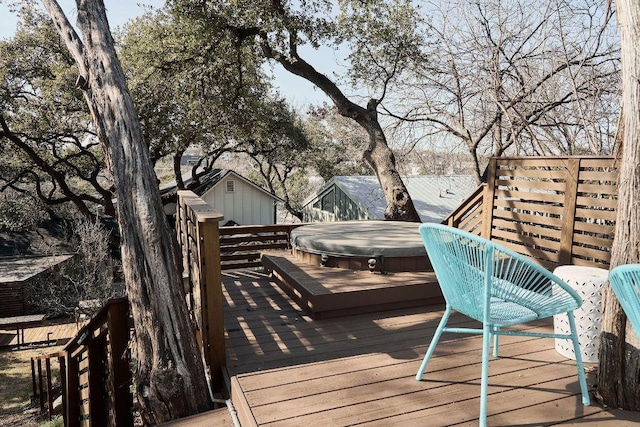 wooden terrace featuring a covered hot tub