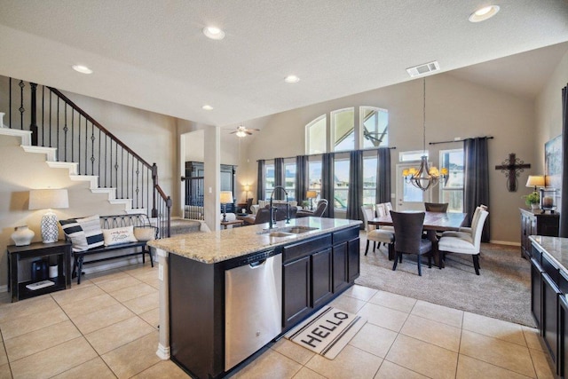 kitchen featuring visible vents, open floor plan, a sink, light stone countertops, and dishwasher