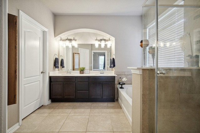 full bath with double vanity, a stall shower, a sink, and a bath