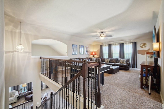 carpeted living area featuring ceiling fan