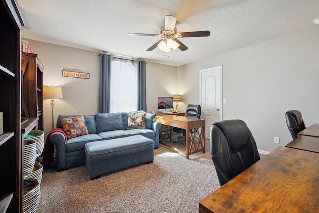 carpeted home office featuring ceiling fan and a textured ceiling