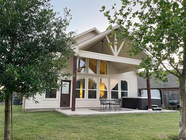 1010 Papaya Cv, Hutto, TX 78634 - back of property featuring a hot tub, a patio area, a yard, and central AC unit