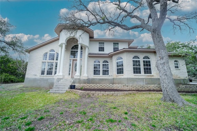 mediterranean / spanish home featuring a front lawn