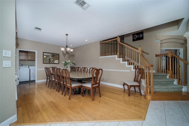 dining room with stairs, independent washer and dryer, wood finished floors, and visible vents