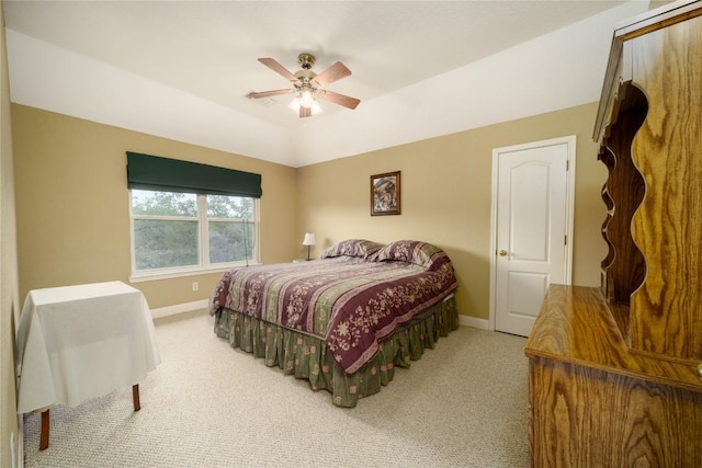 carpeted bedroom with ceiling fan, vaulted ceiling, and baseboards