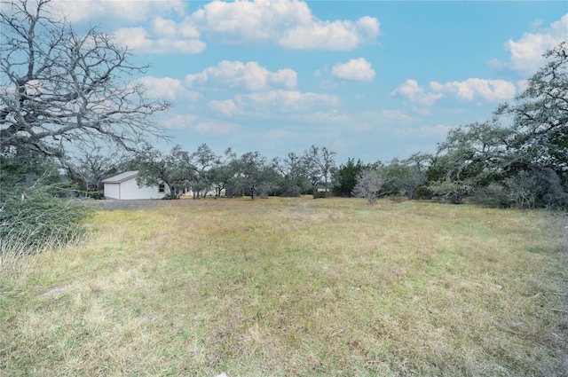 view of yard with a rural view and an outdoor structure