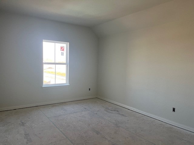 spare room with vaulted ceiling