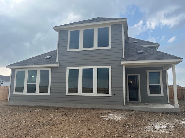 503 Ansley Ct, Taylor, TX 76574 - back of property with a shingled roof and a patio