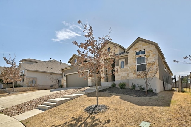 view of front of home featuring fence, concrete driveway, stucco siding, a garage, and stone siding