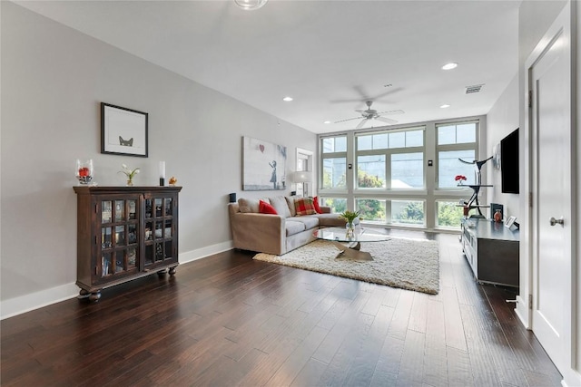 living room featuring dark wood-style flooring, floor to ceiling windows, and baseboards