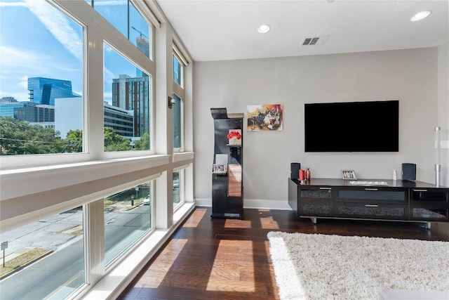 living room with a view of city, dark wood finished floors, recessed lighting, visible vents, and baseboards