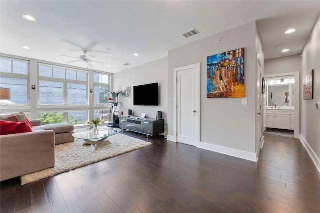 living room with dark wood-style floors, recessed lighting, visible vents, and baseboards