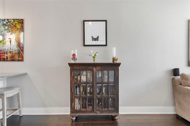 room details featuring baseboards and wood finished floors