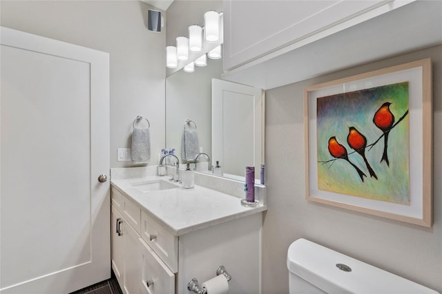 bathroom featuring toilet and vanity