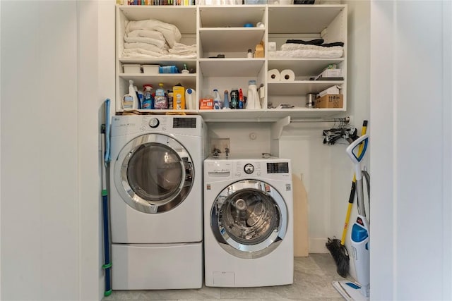 clothes washing area featuring laundry area and washing machine and dryer