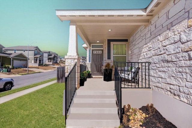 property entrance with stone siding, a porch, and a residential view