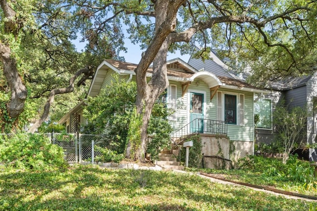 view of front of home with fence and a gate